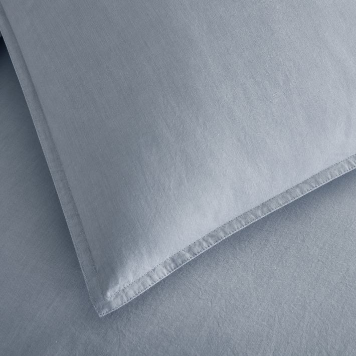 A blue pillowcase with blue sheet.